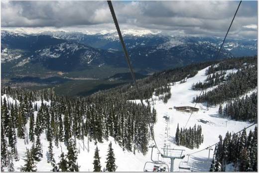 Ski chair above mid-mountain lodge
